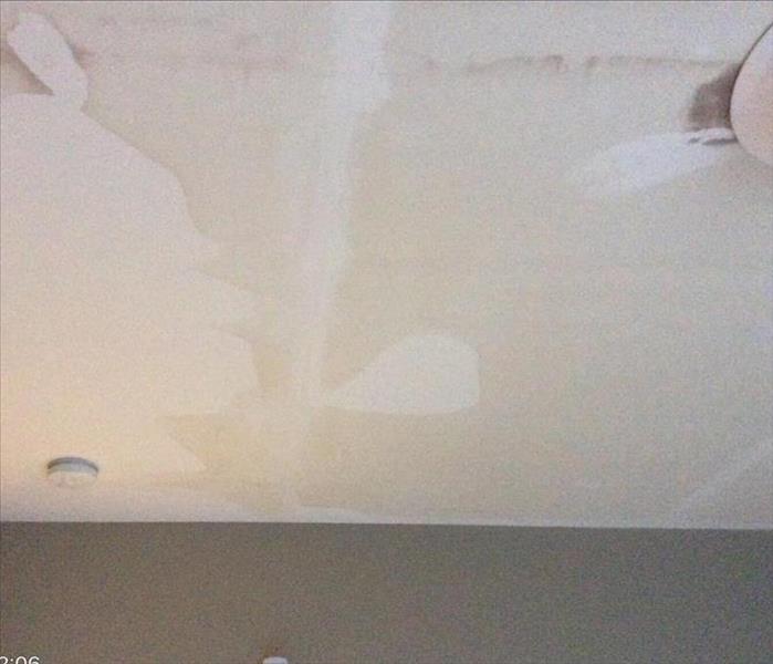 Drywall on ceiling with water stains on them
