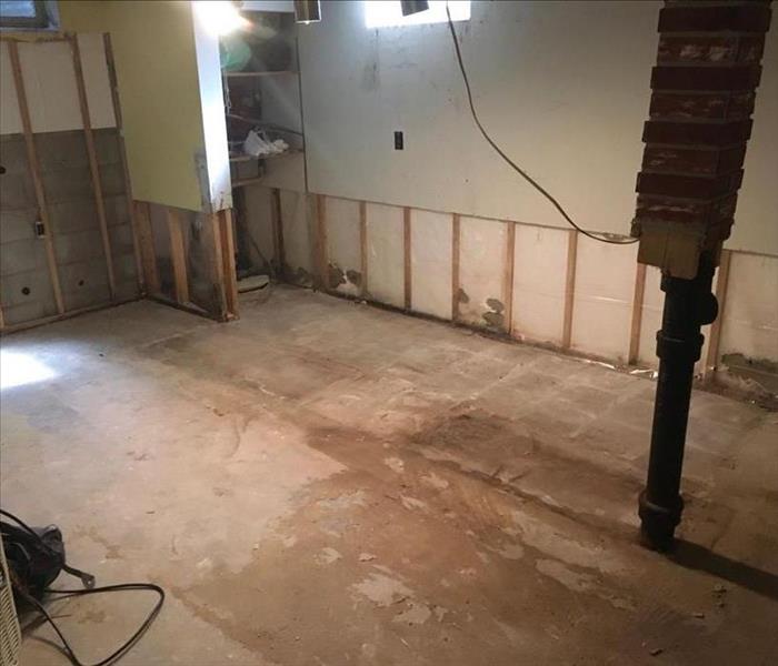 Multiple feet of drywall has been removed from the walls and the walls and floor are completely baron