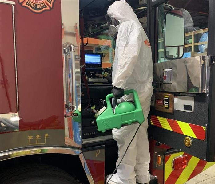 SERVPRO Employee Spraying Disinfectant in a Fire Truck
