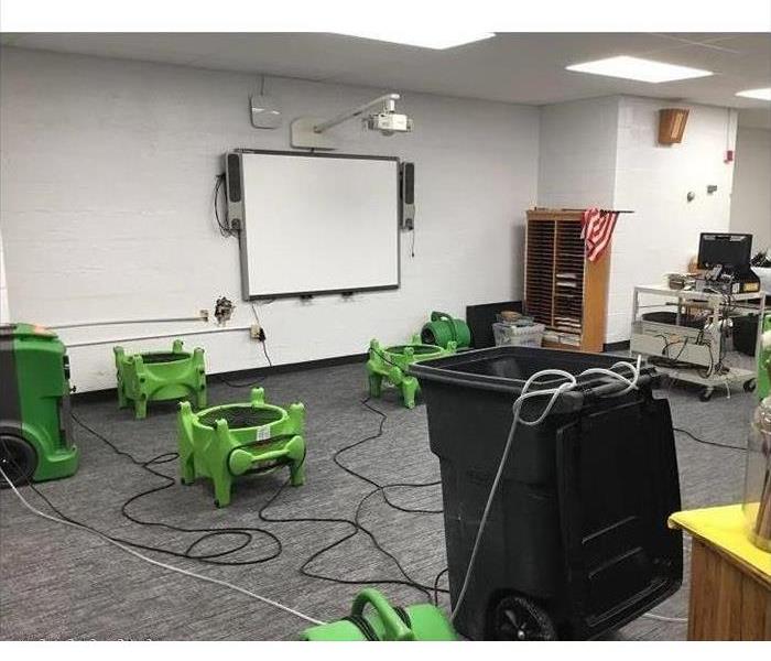 Lots of equipment sit in a school room for drying