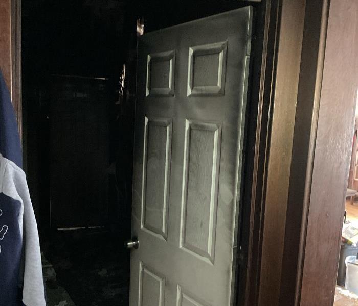 Black soot on white bedroom door