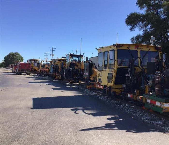 Multiple pieces of large equipment are lined up for cleaning