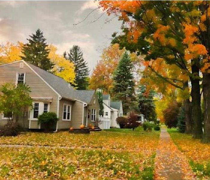 Exterior photo of home with fallen leaves on the ground