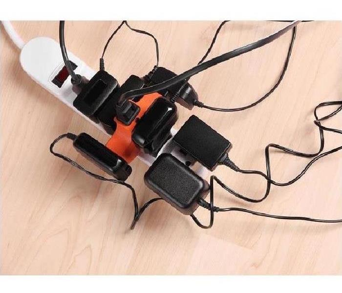 Multiple extension cords plugged into a power strip
