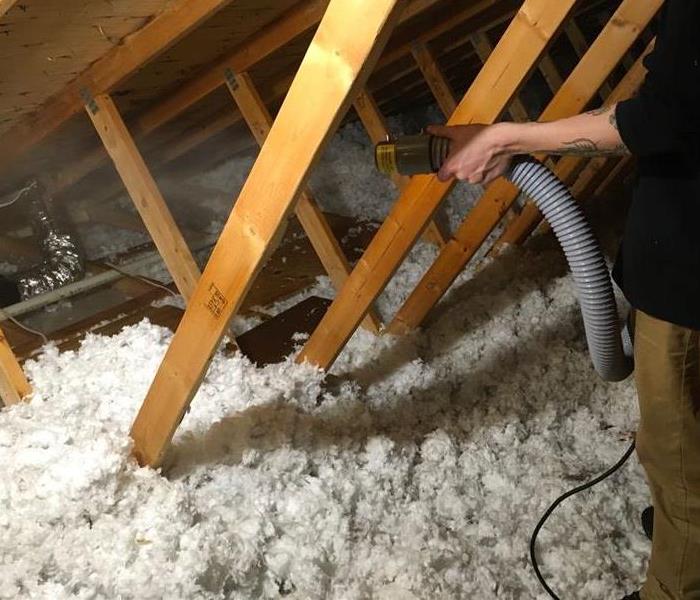 SERVPRO employee using a ULV fogger to spray a disinfectant in the attic