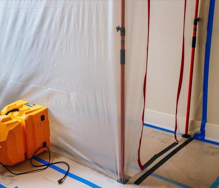 Plastic sheeting creates a small room of containment in a home