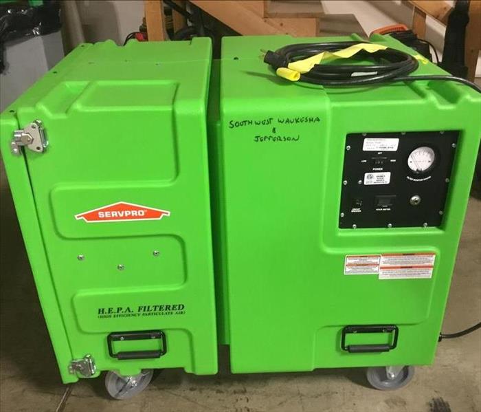 Air scrubber machine encassed in green plastic