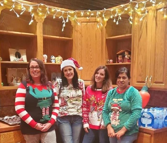An image of our SERVPRO team in their christmas sweaters at the office party