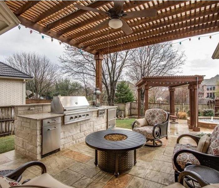 Backyard with grill, chairs, pergola and fire pit.  