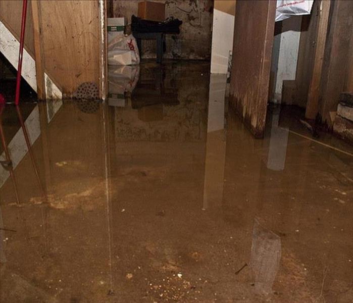 An image of a basement floor covered in water. 