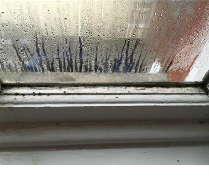 Water droplets on glass window and window sill